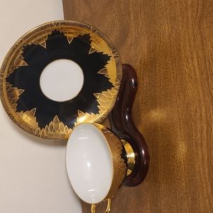 Black and gold tea cup and saucer